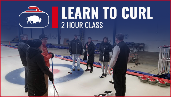 Image of a curling instructor giving directions to a group of people on ice. The instructor is wearing a black vest and the students are wearing comfortable athletic clothing. The ice is a bright white.